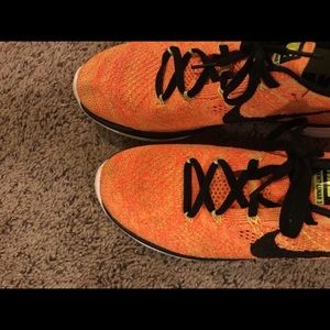 Orange fly knit Nike free running shoes